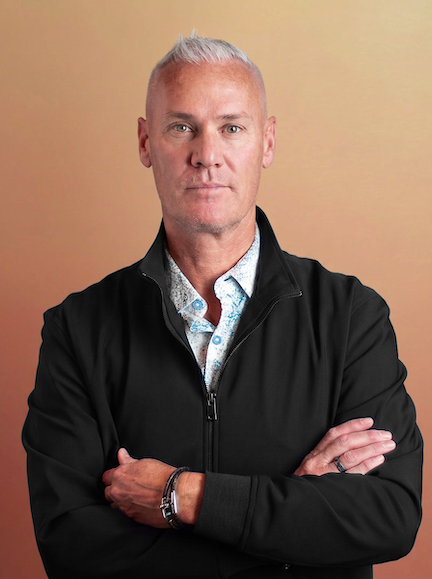 Fletcher Whitwell, President and CEO of B&P, arms crossed against a warm brown backdrop